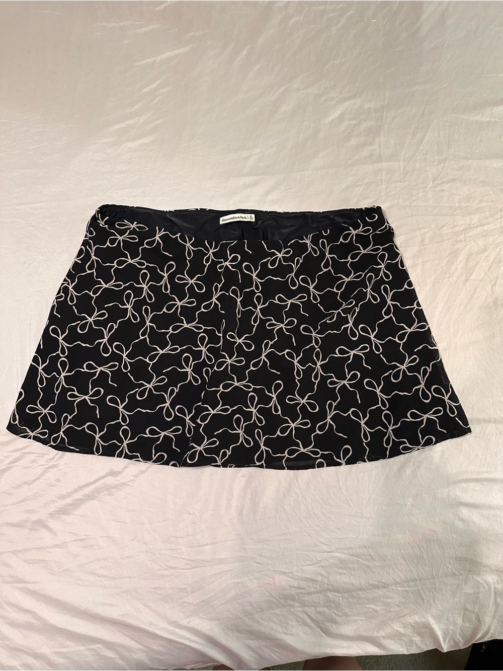Black Patterned Mini Skirt with White Bow Print